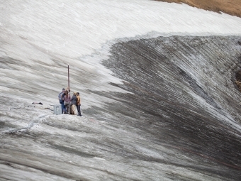 Matt Stirn -Members of INSTAAR, the USGS and US Polar Ice Driling Team use a mechanized and heated drill to extract a long ice core from an alpine glacier in Wyoming's Beartooth Mountains.