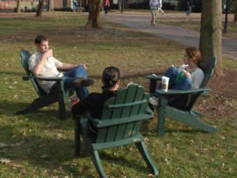 Students sitting in green lawn chairs photo from 2010 sustainability climate action plan report