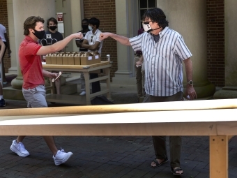 Professor Tim Gfroerer and Student bump fists