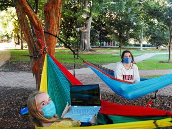 Students Studying in Hammocks with Masks On