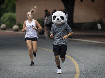 Students Race at Cake Race, one with Panda mask on