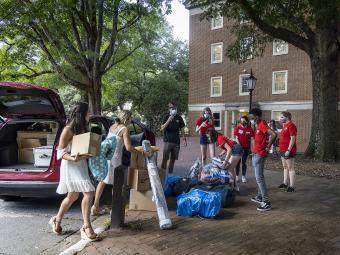 Students Moving in Carrying Boxes and Bags with help from Orientation Team members