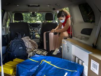 Car full of belonging at move in with helper stepping in