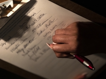 Honor code signing where hand is signing the pledge