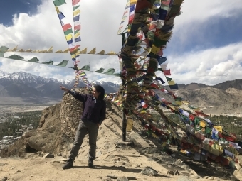 Student pointing into the distance in moutains of Leh, India