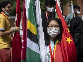 Student in Mask Surrounded by Flags