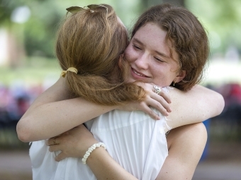 Student Says Goodbye to Family and Hugs Family Member at Farewell Picnic