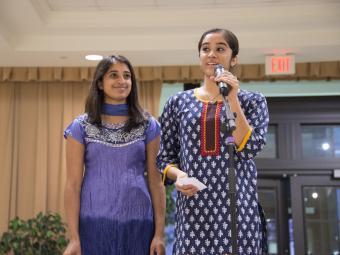 Two students speaking during Diwali celebration