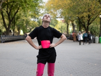Davidson College alum Dan Van Note '14 in thigh-high boot heels with sneakers on ground for 2019 Endurance Queen performance