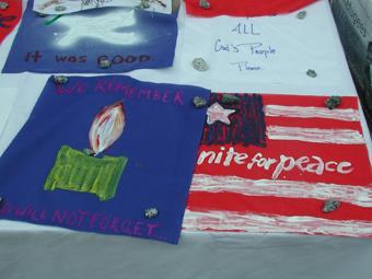 student-painted poster of American flag for peace quilt reads "unite for peace"