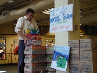 stack of water bottle packs for 9/11 collection drive in Davidson College union