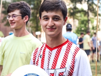 student with frisbee in hand