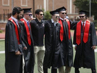 Group of Friends Gather in Regalia at Commencement