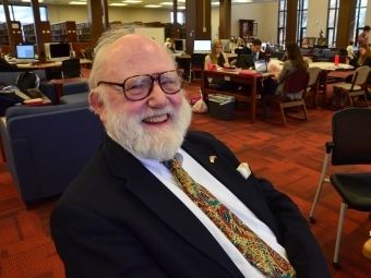 Gill Holland in the Library Smiling