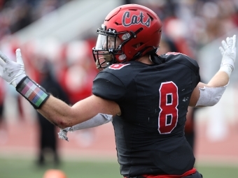 Football Player in Uniform and hands in the air