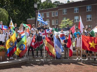 Davidson international students group holds country flags outside college union amphitheatre