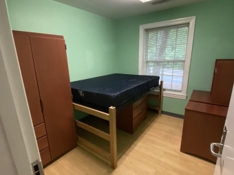Flowe Bedroom with bed, armoire, and desk
