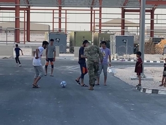 Matthew Hardman Playing Soccer in Army gear with local kids