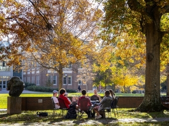 Prof. Patricio Boyer and Students gather outside on a beautiful fall day