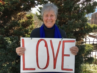 Ruth Pittard holding sign that says "LOVE"