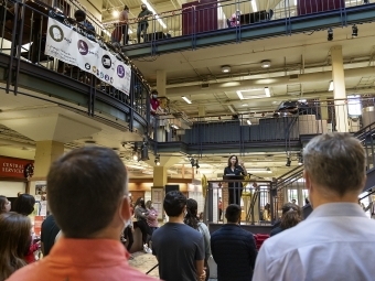 crowd of students and staff listen to President Carol Quillen speak at celebration