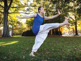 Davidson Dance Professor Dasha Chapman in Haitian dance pose outdoors