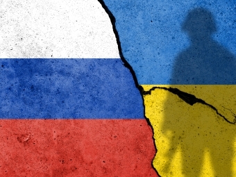 Russian and Ukraine Flags on Cracked pavement