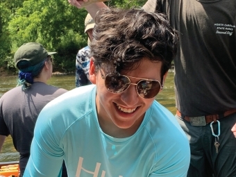 Portrait of Raul Galvan ’21 holding a hellbender salamander