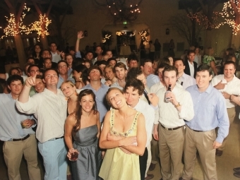 Molly and David at their wedding with friends and fireworks