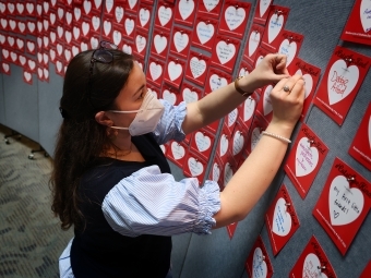 Student Pinning Up Gratitude Card