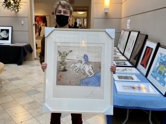 student holds Dali artwork