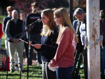 students speaking in microphone at vigil for Ukraine