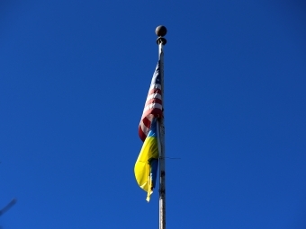 campus flagpole with U.S. and Ukraine flag hanging