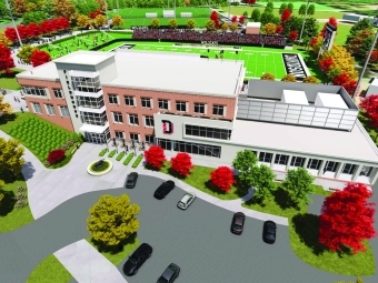 new Game Changers Fieldhouse with parking lot in front and stadium behind it