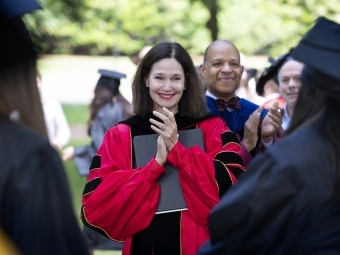 Carol Quillen smiling at commencement in crowd of people