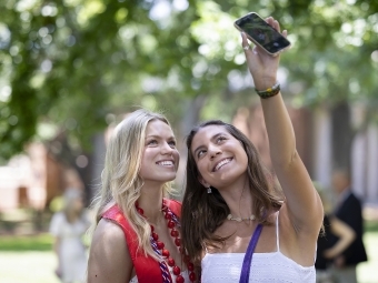 Pair of graduates taking picture at Commencement 2020