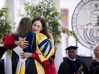 President Quillen hugs student at Commencement 2022
