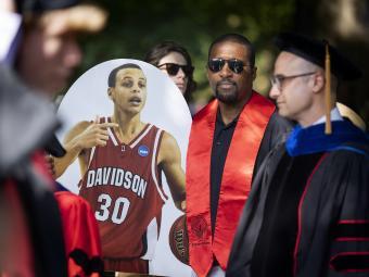 Athletic Director Chris Clunie with cutout of Steph Curry at Class of 2022 Commencement