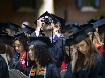 Student taking picture with camera at Class of 2022 Commencement