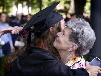 Graduate hugging family member at Class of 2022 Commencement
