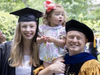 Madeline Buitendorp, Chris Marsicano and child posing for picture at Class of 2022 Commencement