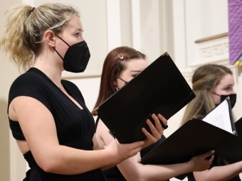 Davidson Chorale singing and holding books