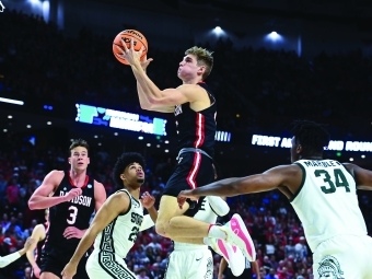 Davidson basketball player jumping to dunk the ball