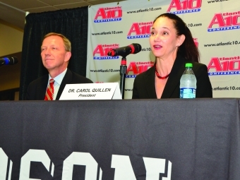 Carol Quillen and guest speaker seated at A10 conference podium table 