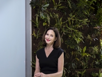 President Carol Quillen in front of plant wall