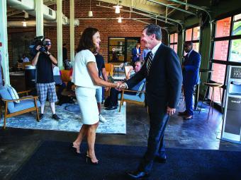 Carol Quillen shakes hands with North Carolina Governor Roy Cooper