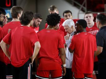 Coach McKillop huddles with team on court