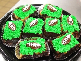 Cupcakes with footballs piped in frosting on top