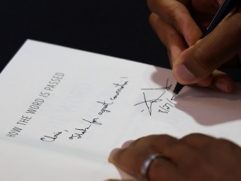 Clint Smith signing a copy of his book