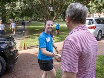 Move In Day 2022 Doug Hicks shaking a student's hand